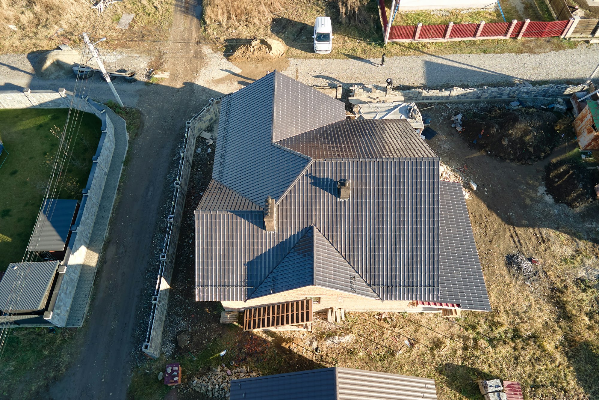 Aerial view of house roof top covered with ceramic shingles.