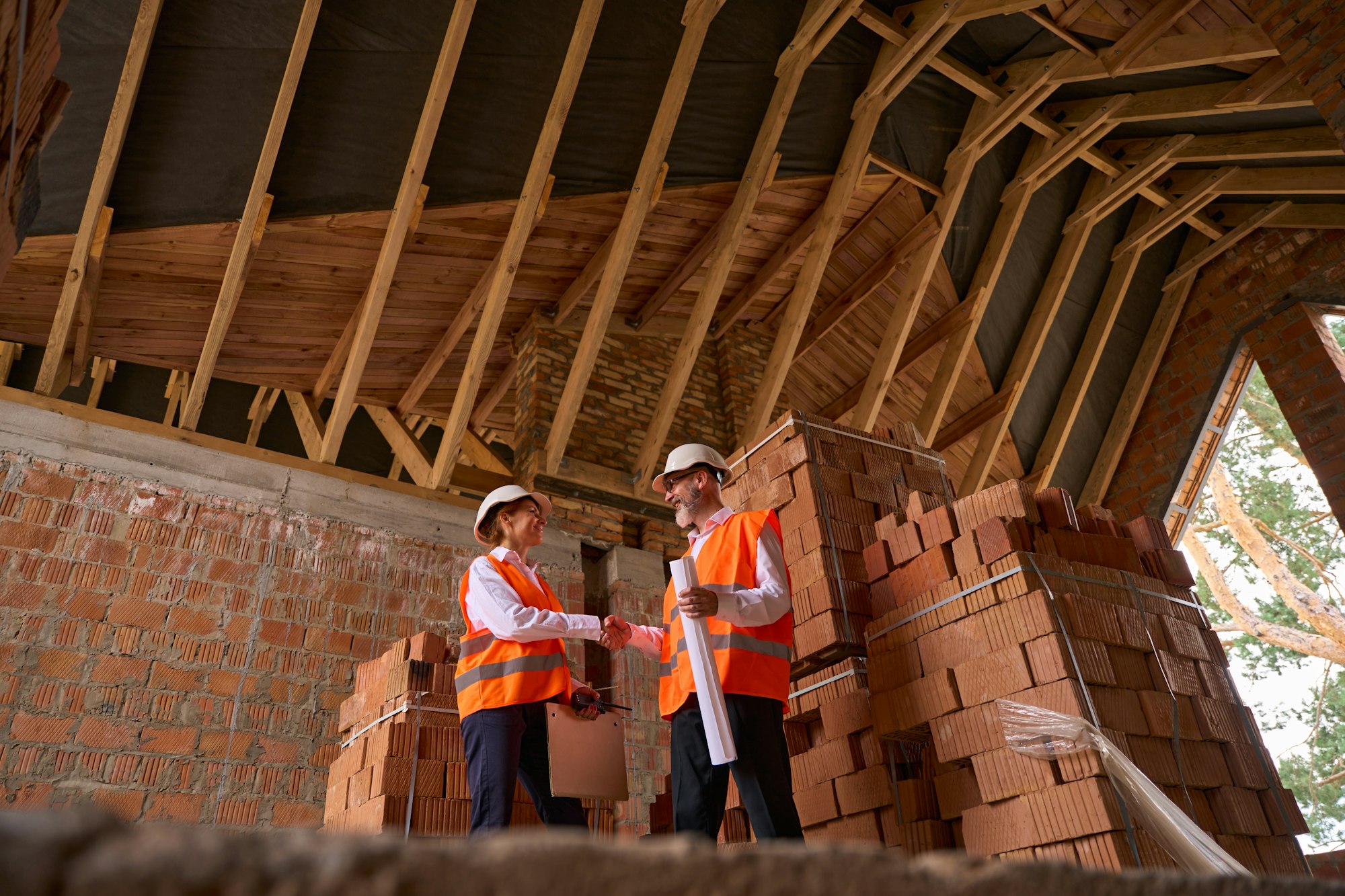 Manager and contractor greeting each other on new construction site