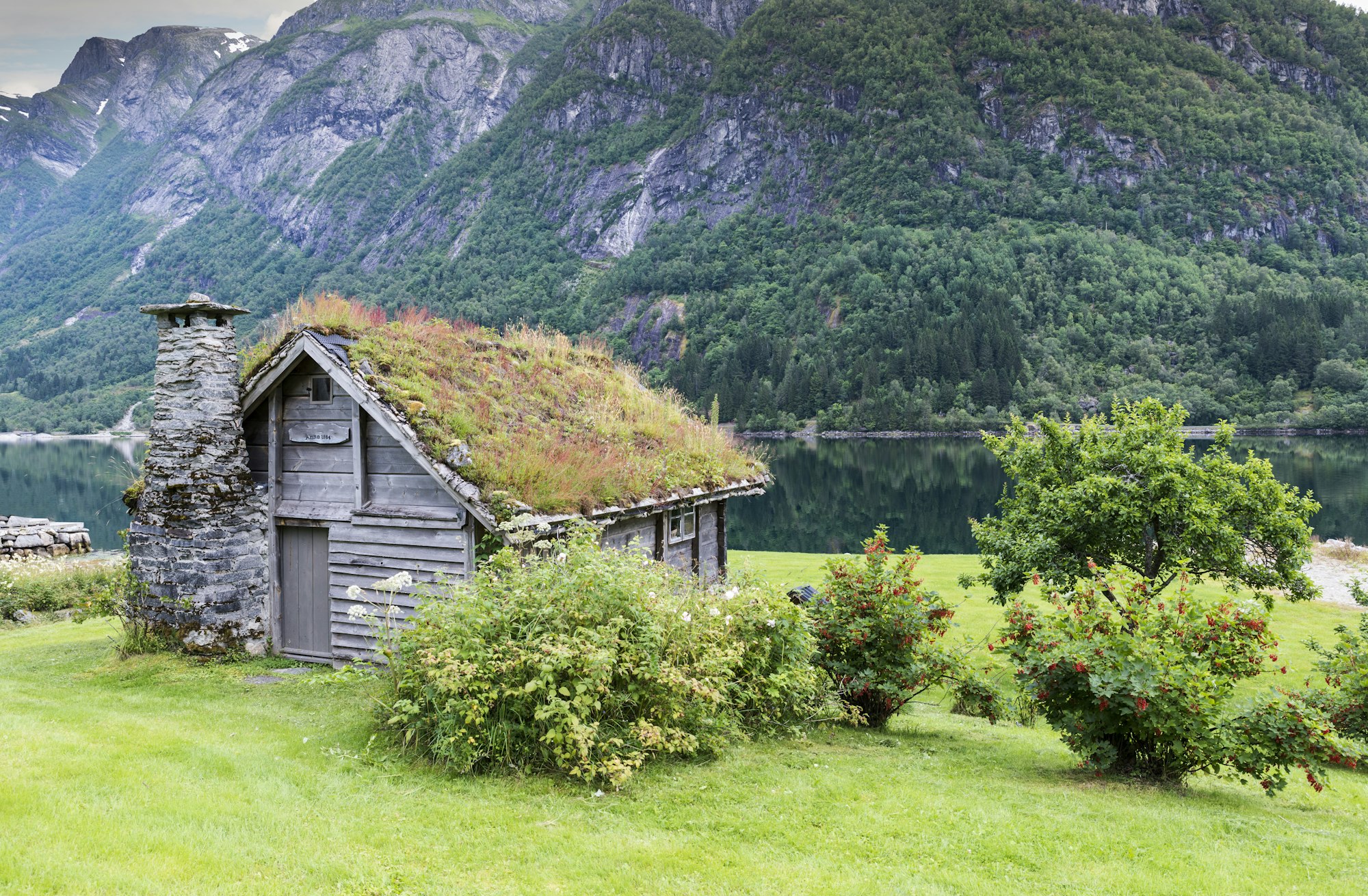 old fairytale like house of wood with chimney of stacked slate