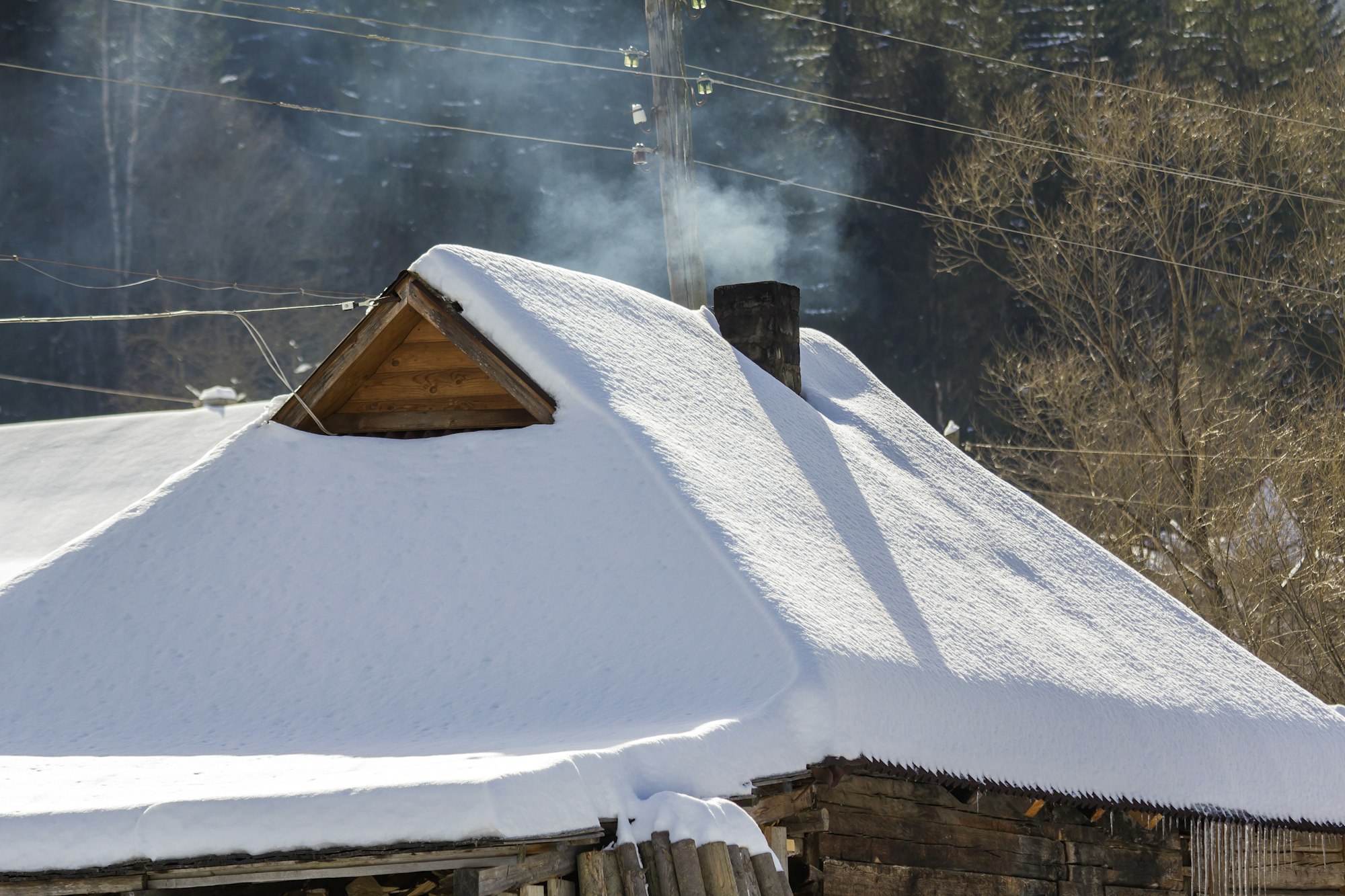 Top of old wooden hut or barn of lumber materials with steep roof